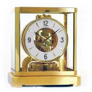 golden clock with white dial